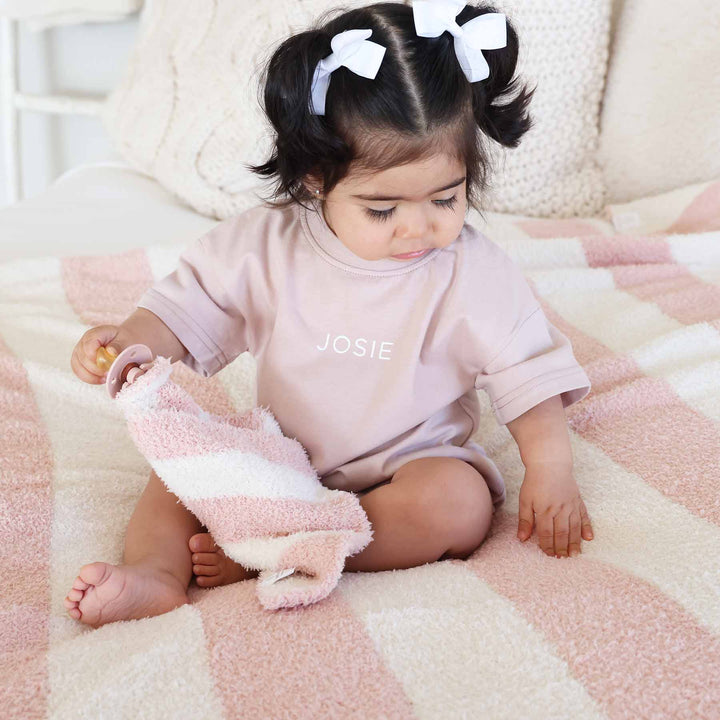 cuddlelane luxe stripe collection with a pink and white microfiber blanket and lovey 