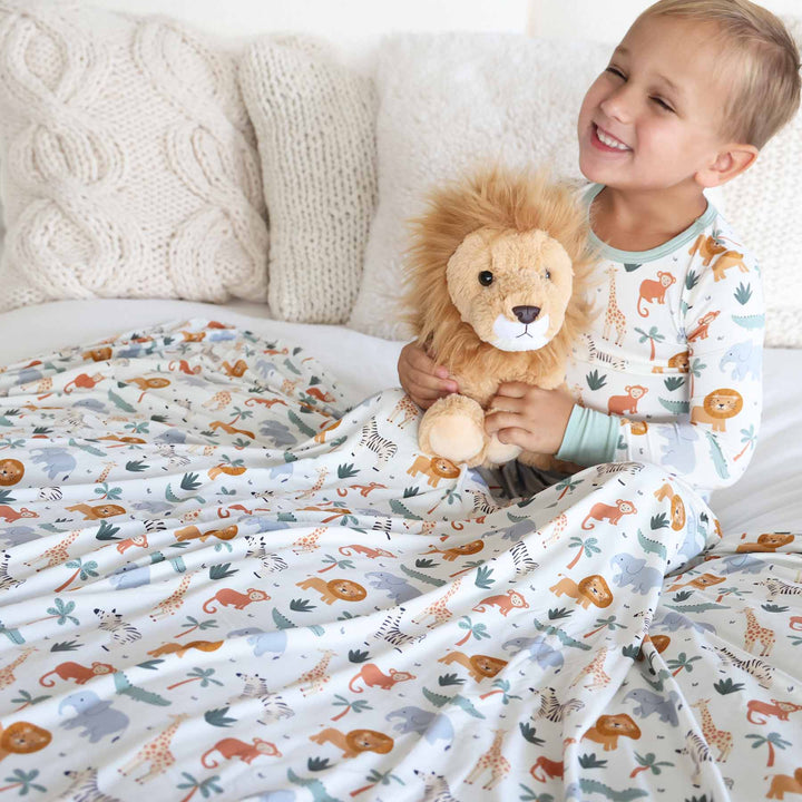 white, green and orange safari themed double sided bamboo blanket for kids with matching pajamas and lion stuffed animal 