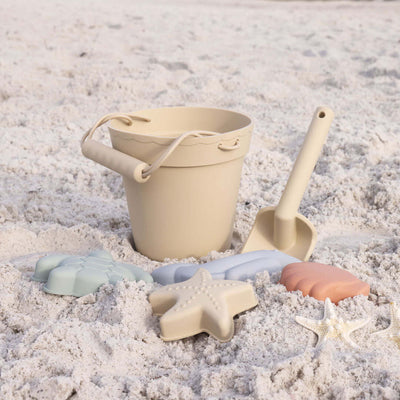light yellow beach bucket with sand molds 