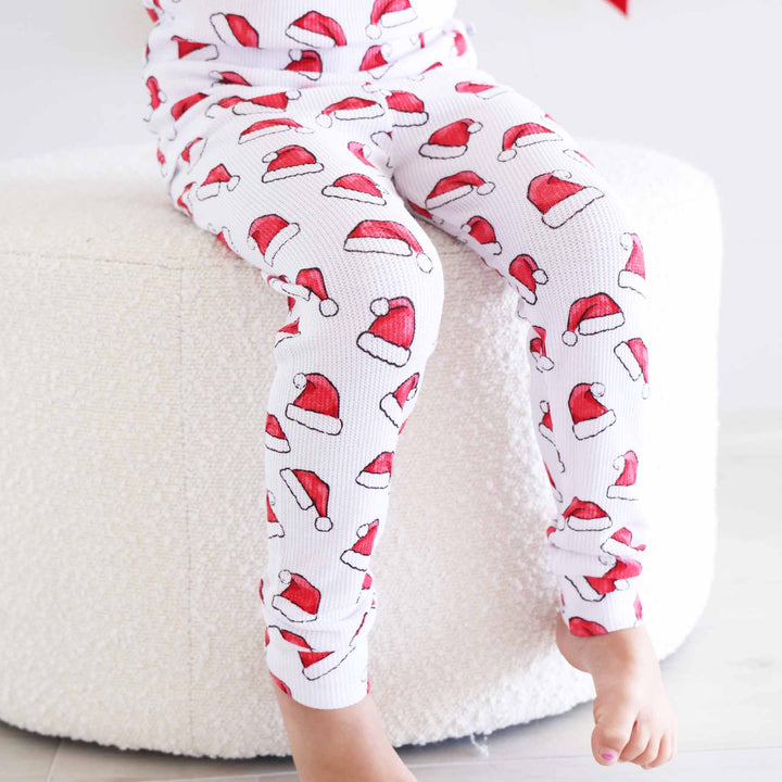 two piece long sleeve and pant pajama set for kids with santa hats 
