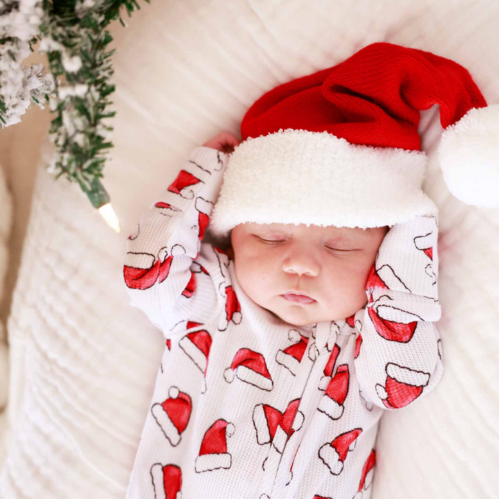 sibling matching christmas pajamas with santa hats 