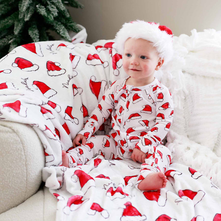 gender neutral christmas blanket with red santa hats 
