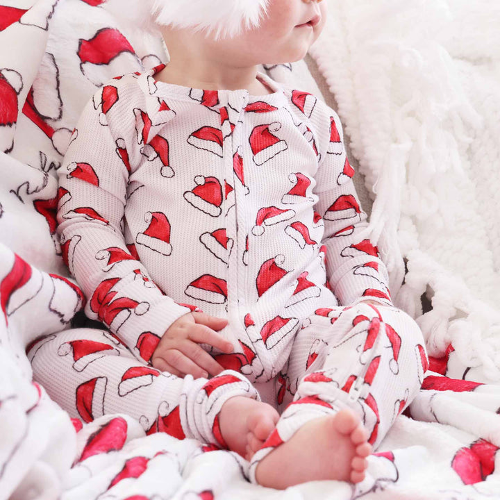 red and white santa hat bamboo waffle convertible zip romper pajama for baby and toddler girls 