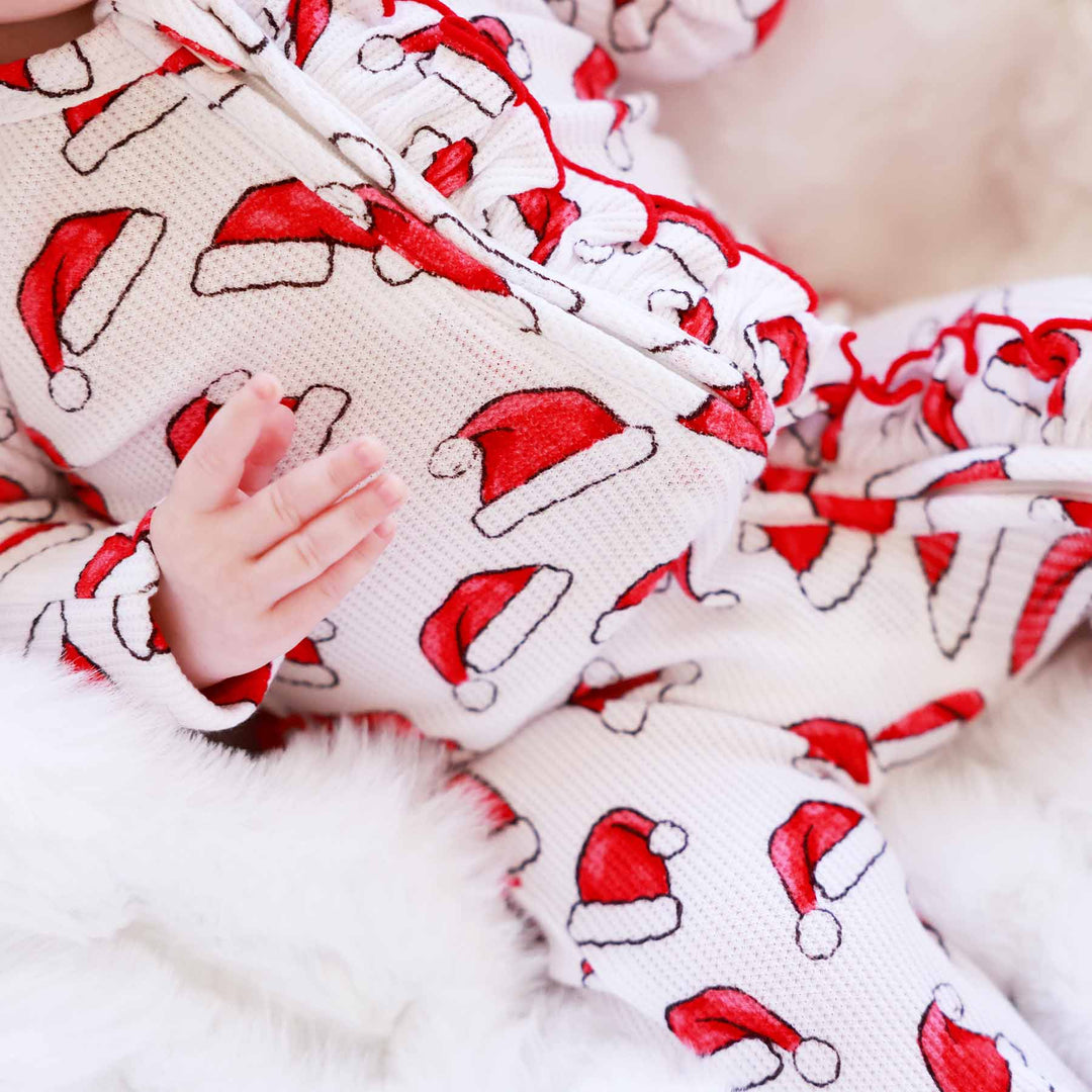 red and white santa hat bamboo waffle baby footie sibling matching christmas pajamas 