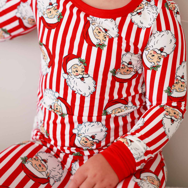 red and white stripe pajamas with santa heads 