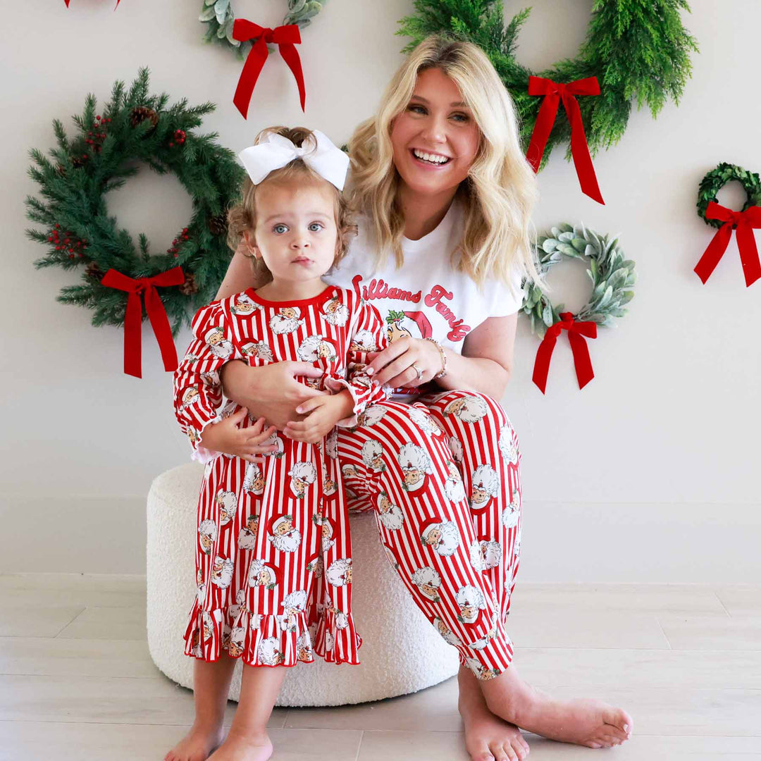 Woman wearing the Santa Family Christmas Personalized Adult Graphic Tee in White and little girl wearing the matching nightgown