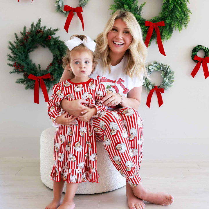 Woman wearing the Santa Family Christmas Personalized Adult Graphic Tee in White and little girl wearing the matching nightgown