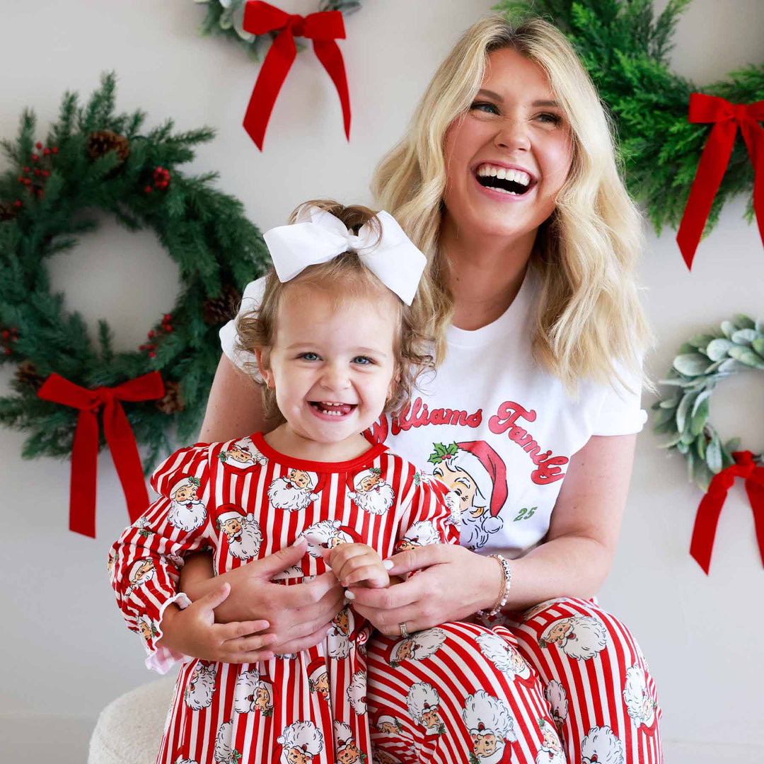 Woman wearing the Santa Family Christmas Personalized Adult Graphic Tee in White and little girl wearing the matching nightgown