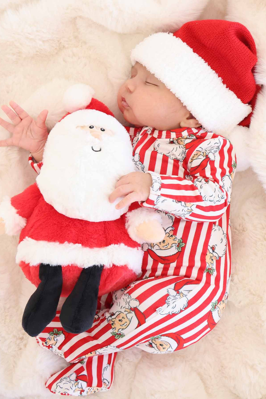 Baby in red santa hat with Caden Lane stripped santa claus lane footie