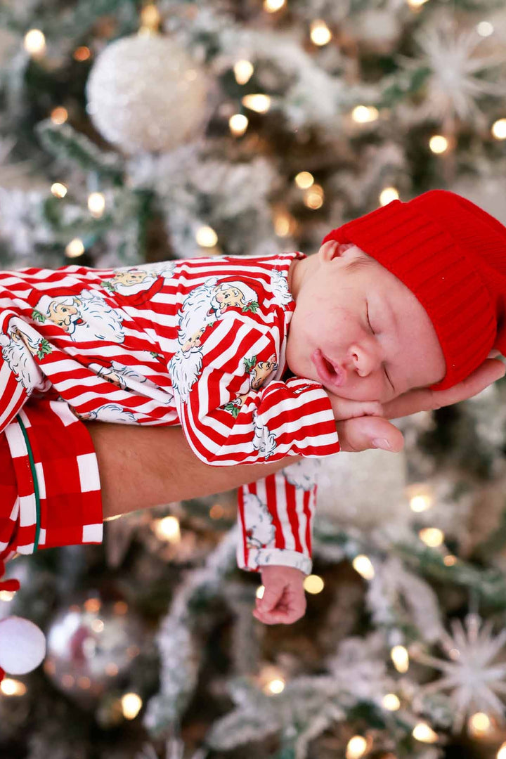 Baby in red hat with Caden Lane stripped santa claus lane footie