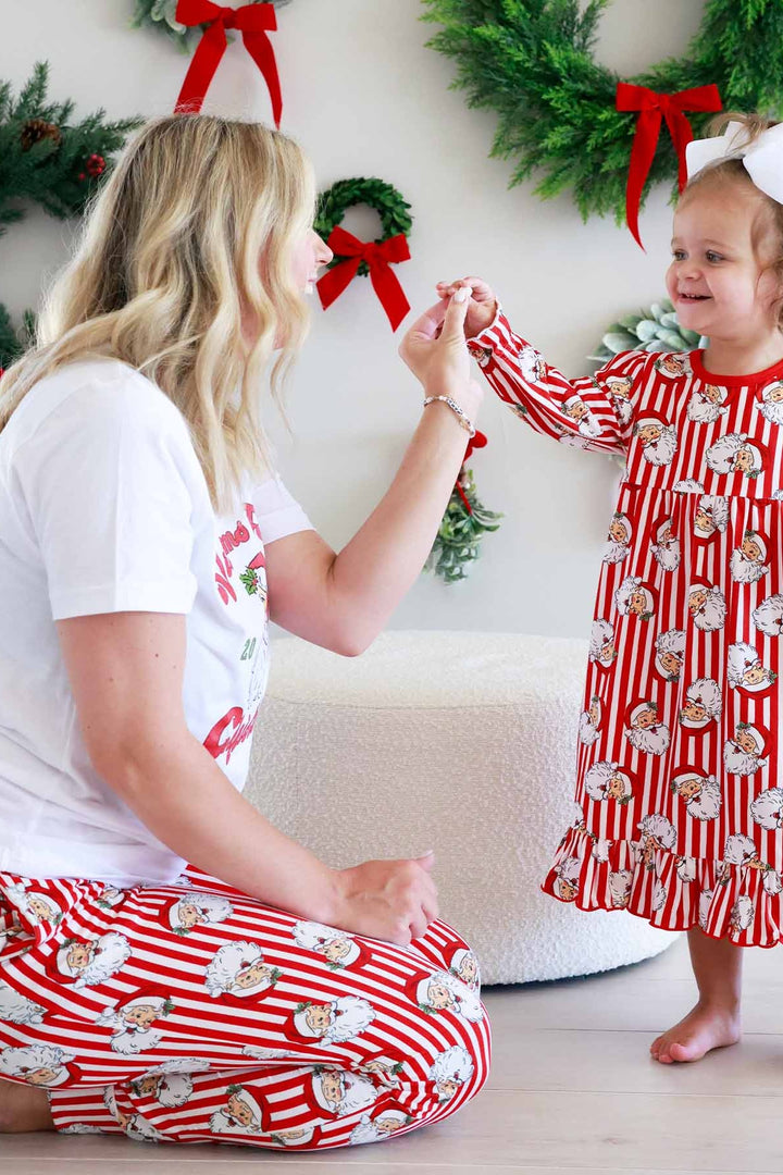 Mother and daughter in matching red-and-white Caden Lane striped Christmas pajamas with a vintage Santa print