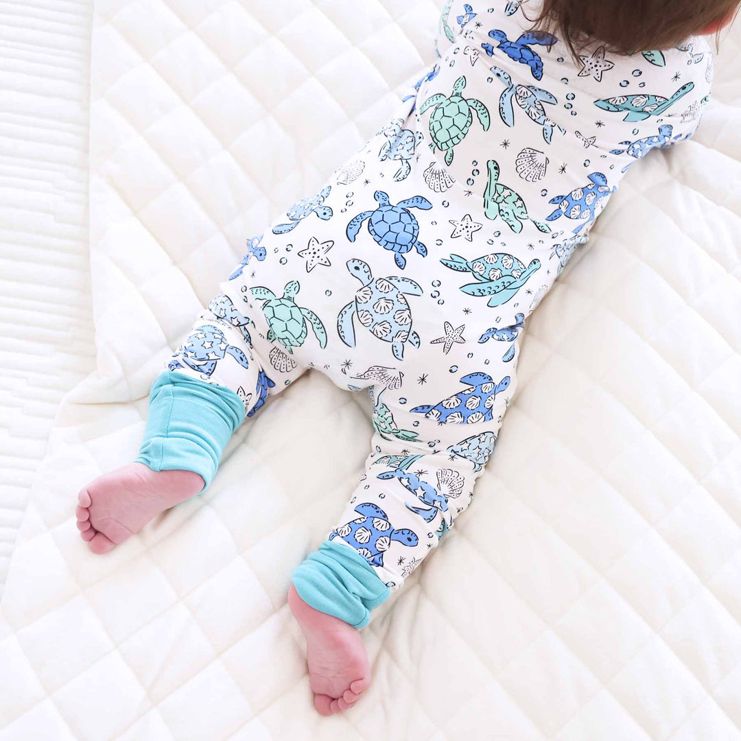 blue and green sea turtle pajama romper for babies 