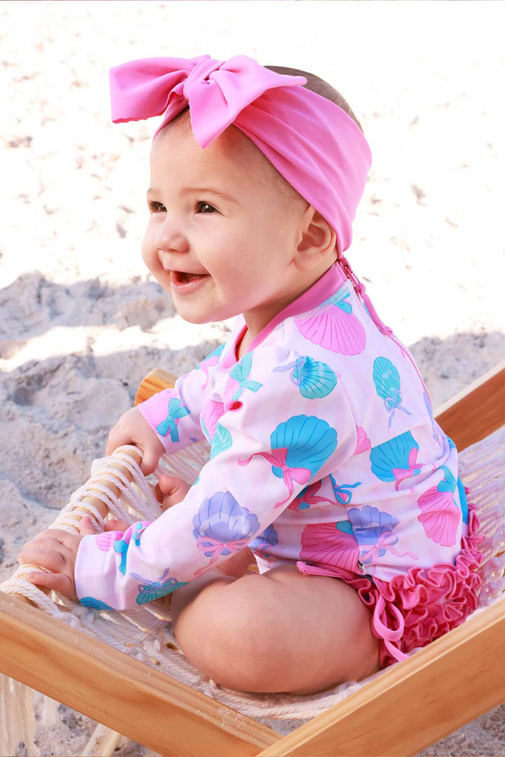 seaside sweetie rash guard swimsuit for girls with pink ruffles on the bottom 
