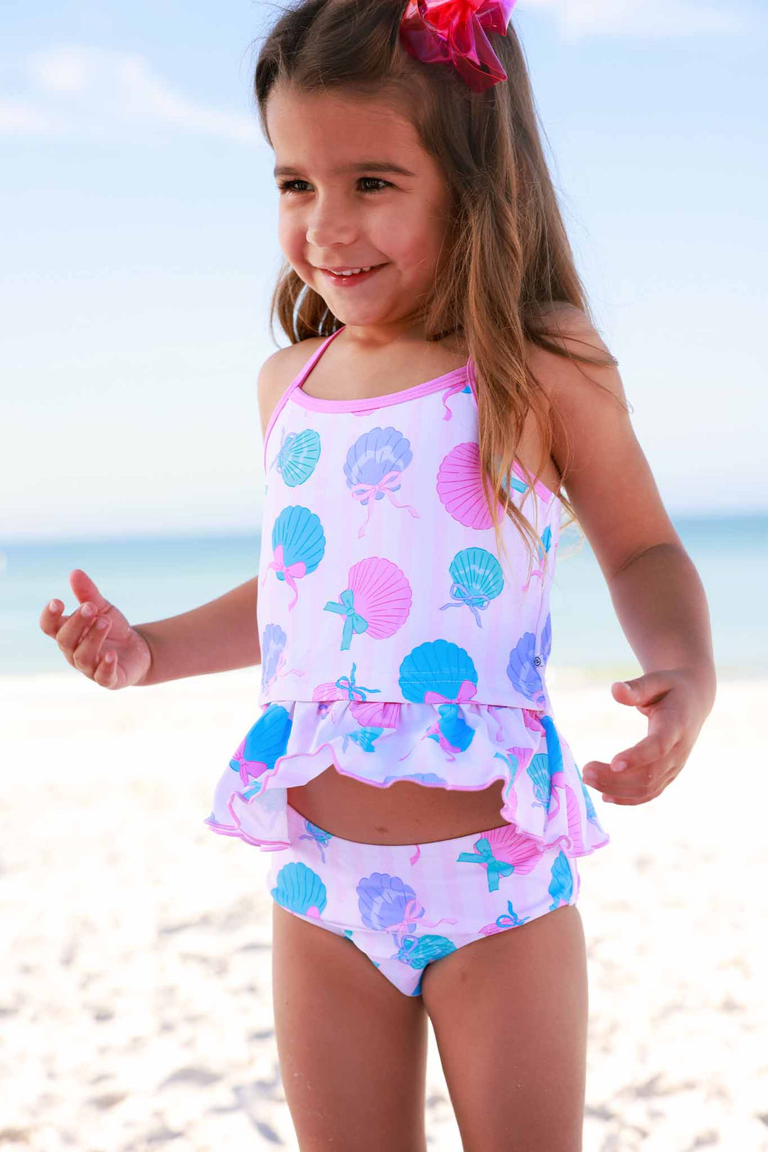 girl standing on the beach in strappy two piece tankini in seaside sweetie 