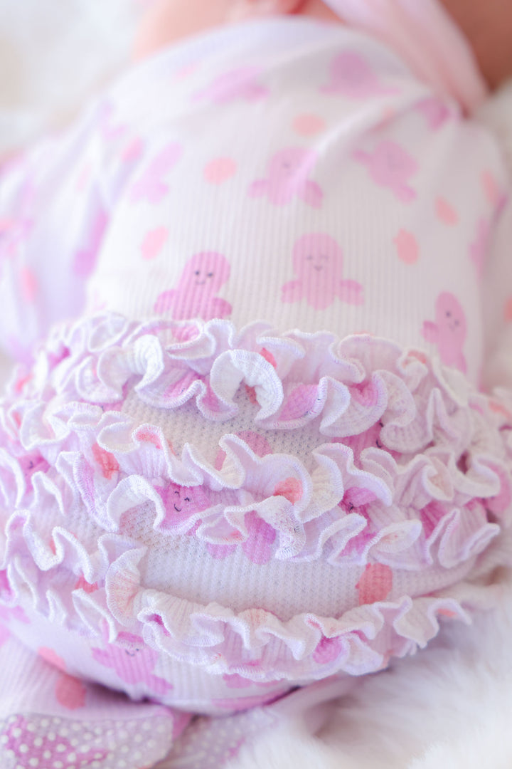 close-up detail of layered ruffle trim on sea snuggles bamboo waffle ruffle zipper footie for newborns