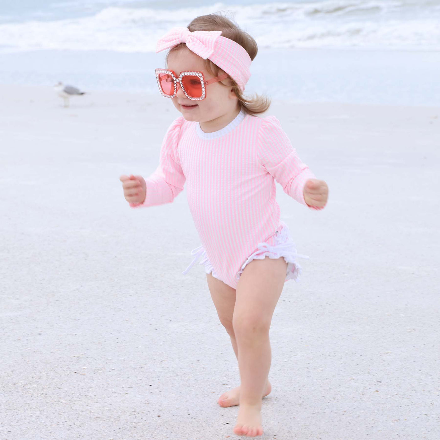 seersucker pink ruffle bottom rash guard swimsuit for babies long sleeve 