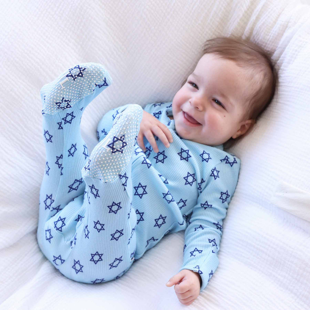 baby boy wearing blue hanukkah pajamas 