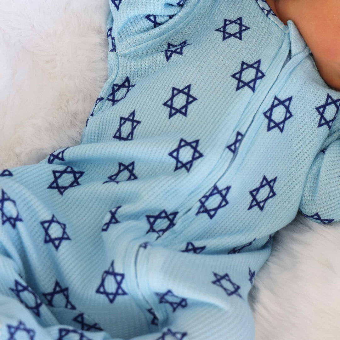 close up of hanukkah bamboo waffle baby footie sky blue with navy stars of david