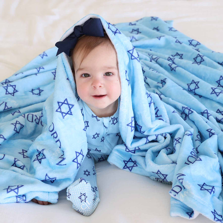 baby wearing hanukkah footie with a matching personalized blanket 