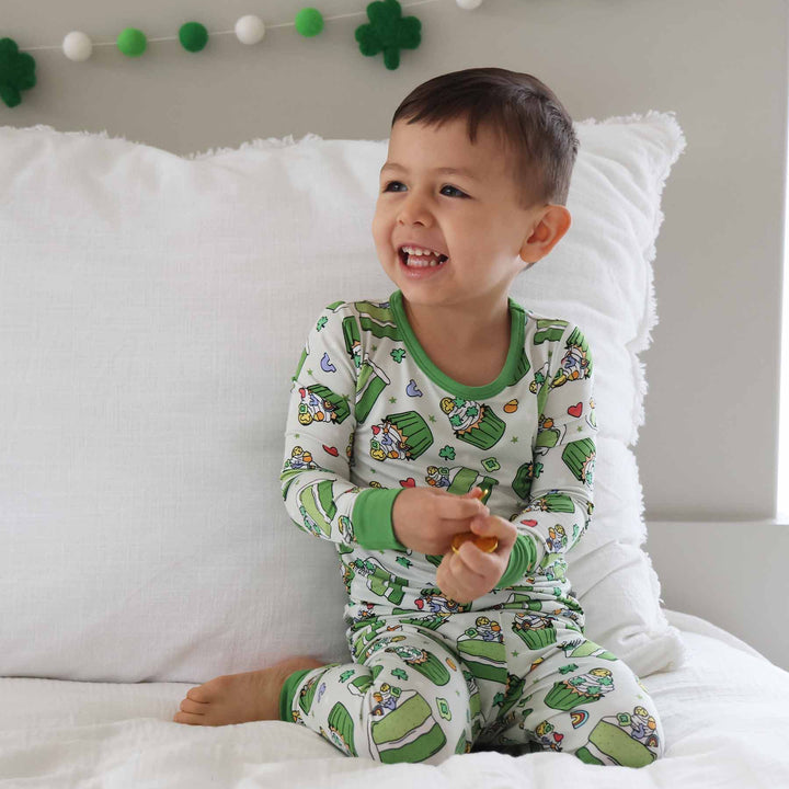 smiling boy wearing st. patrick's day cake and cupcake kids two piece pajama set 
