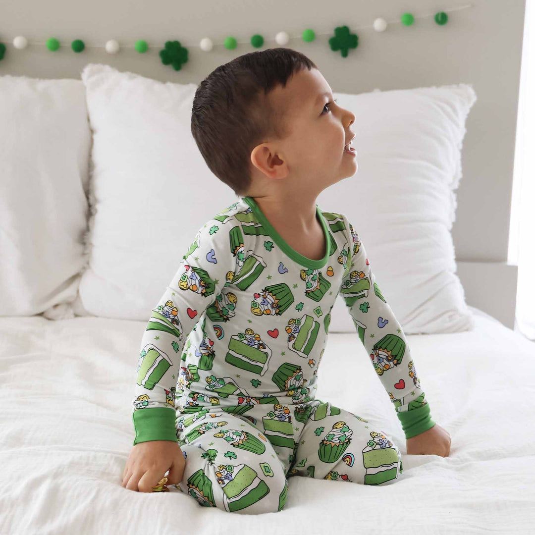 boy's long sleeve st. patrick's day pajama set with green cupcakes and cake on it