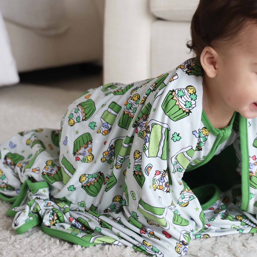 Baby crawling while having the Shamrock Sweets matching Double Sided Bamboo Blanket on him