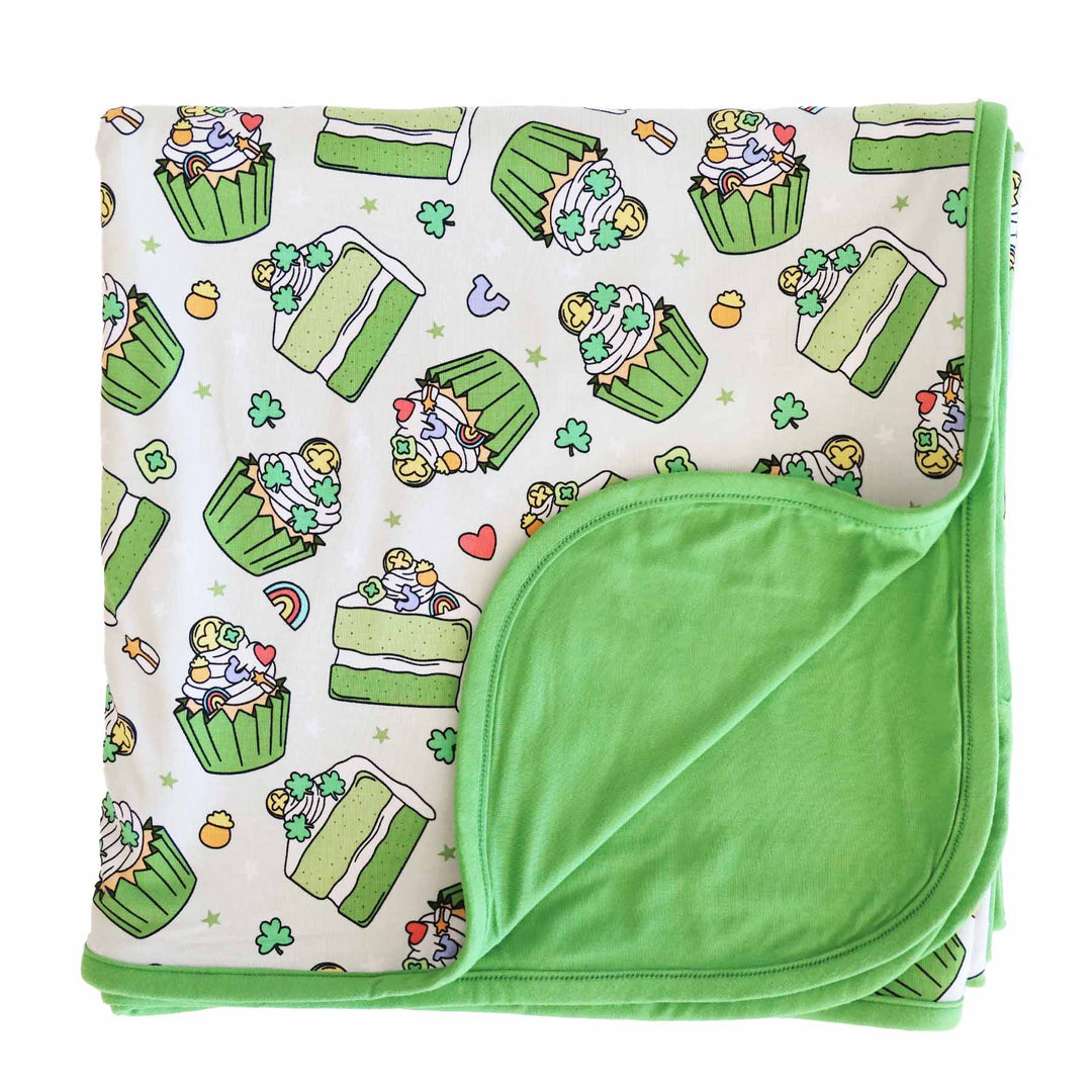 Flat lay of Shamrock Sweets Double Sided Bamboo Blanket