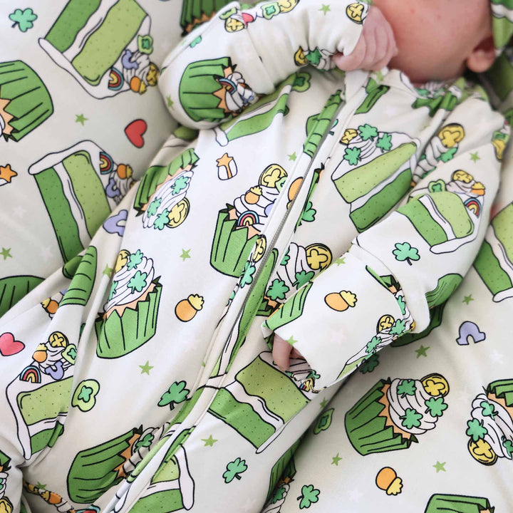 closeup of green cake slices and cupcakes with lucky charms and clovers on top 