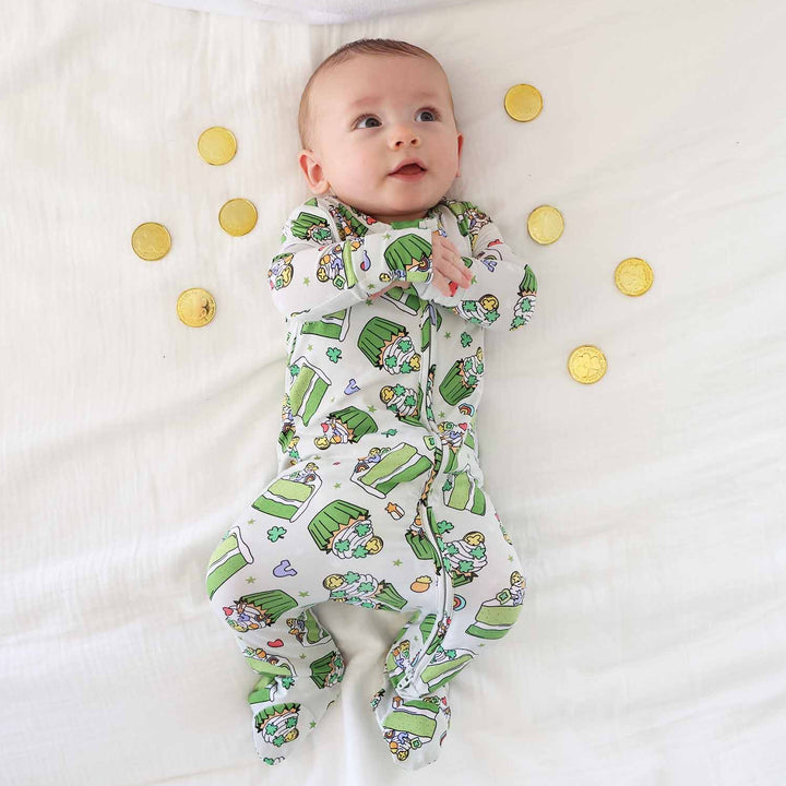 boy wearing a st patrick's day dessert zipper footie surrounded by gold coins 