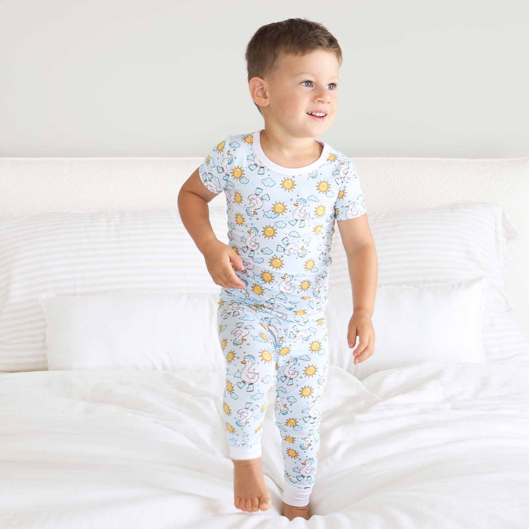 kids two piece pajama set with geese with boots, hat, clouds and suns 