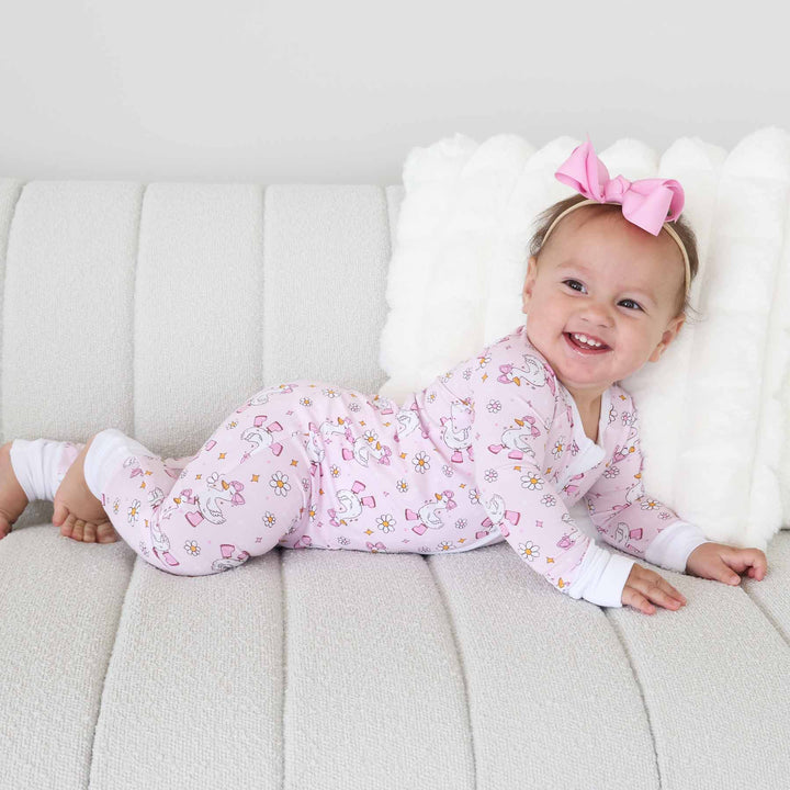 girl goose with a pink bow and boots and daisy convertible zip romper pajama for babies and toddlers