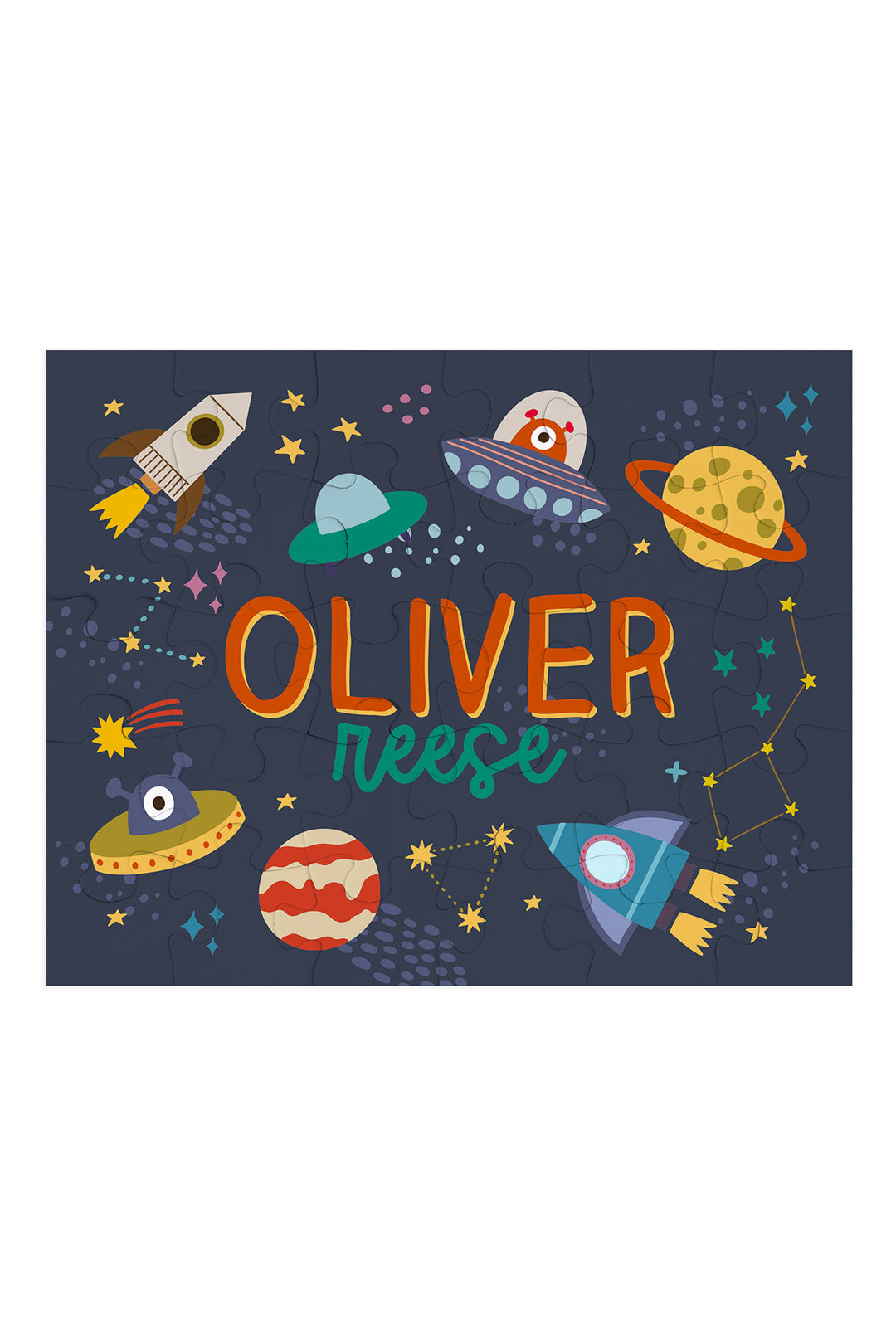 Flat lay of an assembled personalized Caden Lane Star Explorer jigsaw puzzle in navy, showing rockets, planets, and custom name