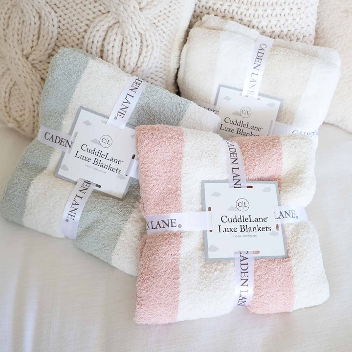 group of striped microfiber blankets in sage, rose and toffee