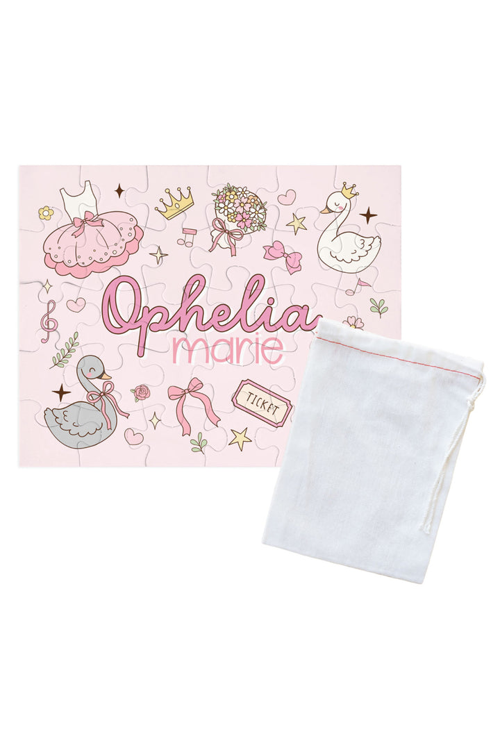 Personalized Caden Lane Swan Ballet jigsaw puzzle in pink, showing ballet dress, swan, and custom name, paired with a white drawstring storage bag