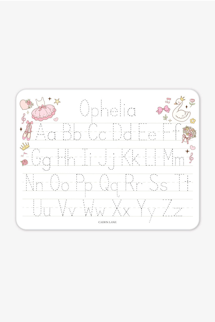 Flat lay of a personalized Caden Lane Swan Ballet alphabet whiteboard, showing ballet dress, ballet slippers, swan, and tracing letters with custom name