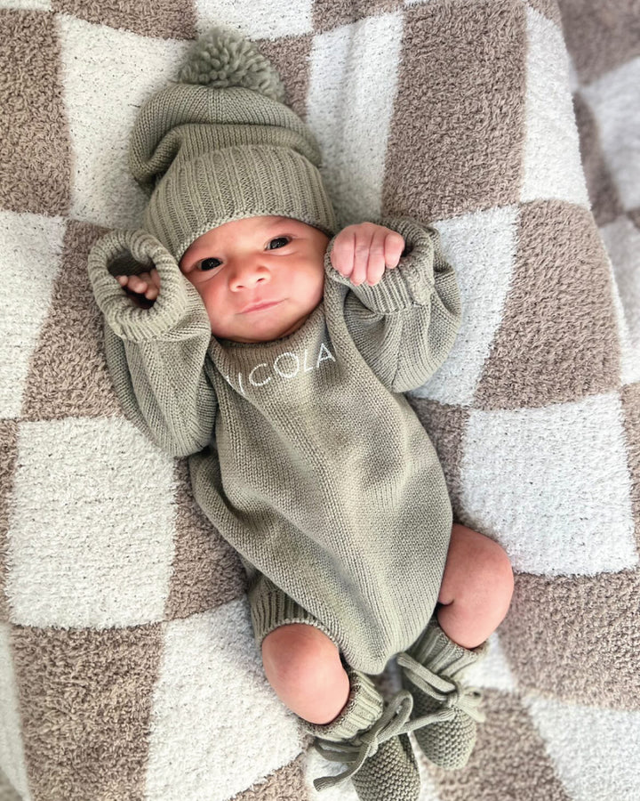 Baby wearing a Personalized Printed Knit Sweater Bubble in the color Smoke, with matching hat & booties