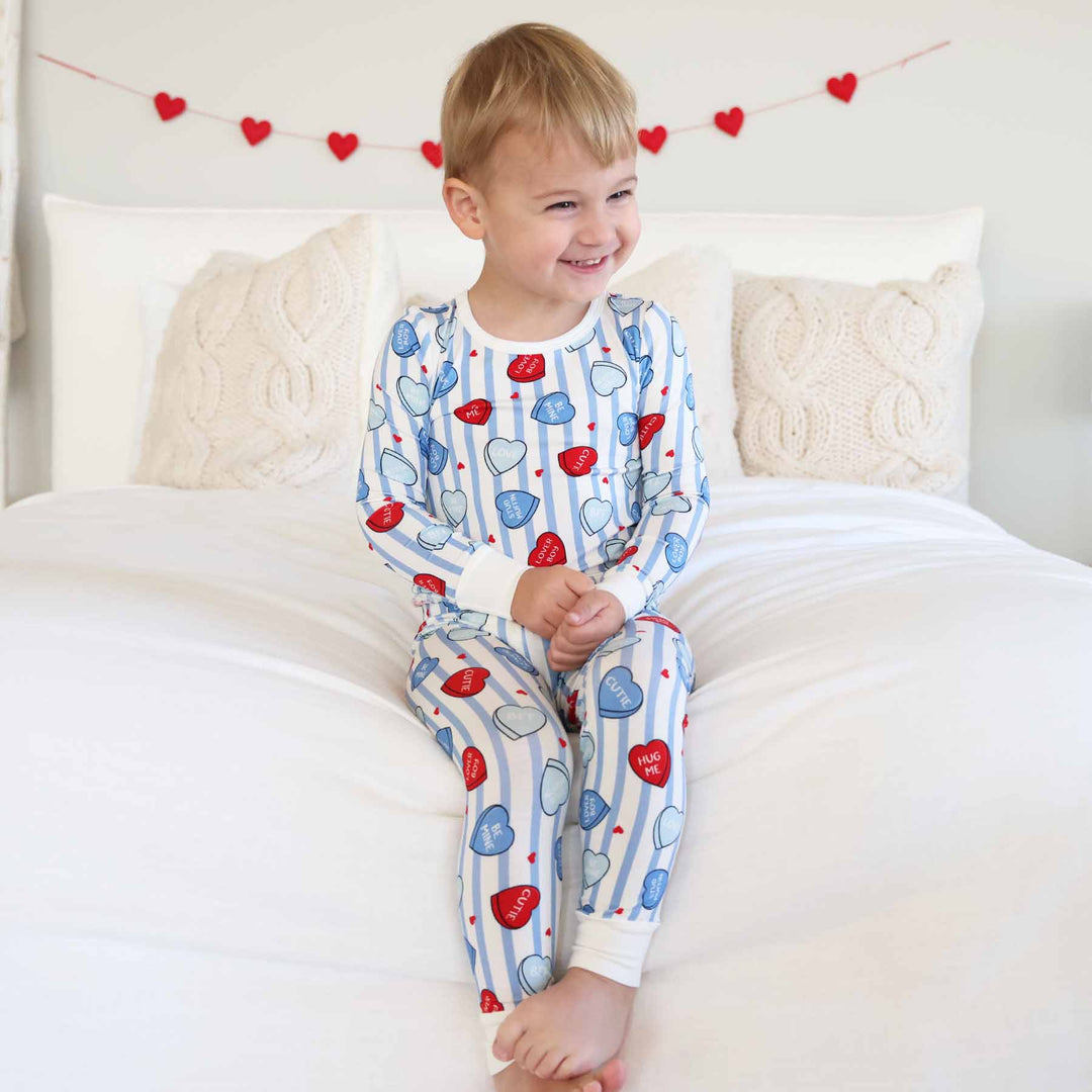 sibling matching valentine's day pajama sets with stripes and candy hearts 