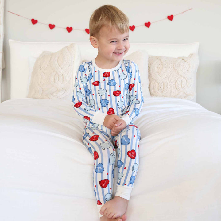 sibling matching valentine's day pajama sets with stripes and candy hearts 