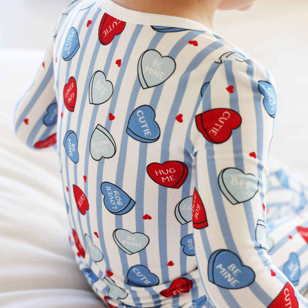 closeup of red and blue candy heart valentine's day pajama set for boys with long sleeves and pants 