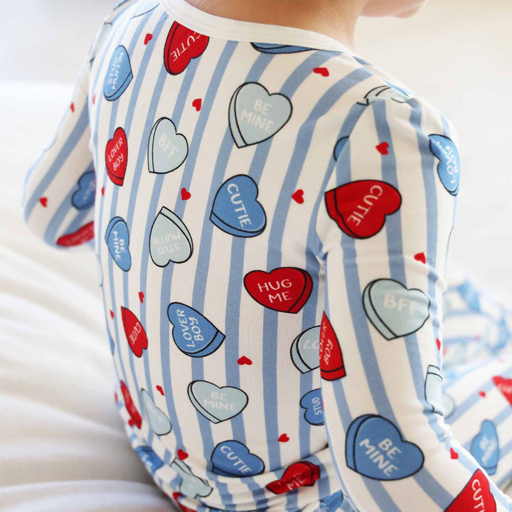 closeup of red and blue candy heart valentine's day pajama set for boys with long sleeves and pants 
