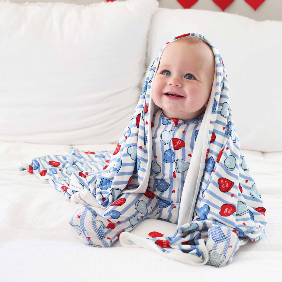 sweet like candy blue baby boy valentine's day footie pajama with a matching blanket over his head 