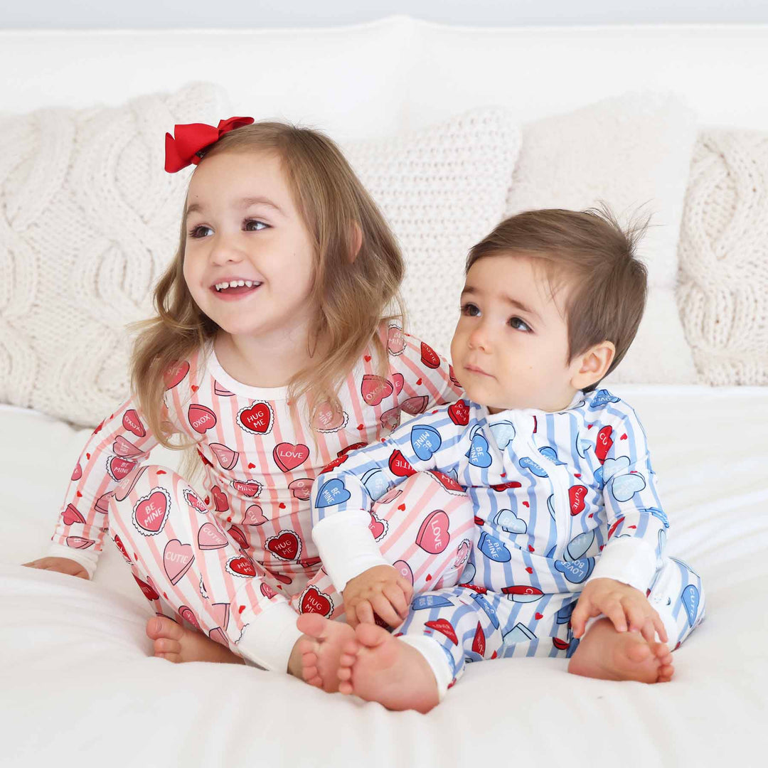 valentine's day sibling matching pajamas with stripes and conversation hearts in pink and blue