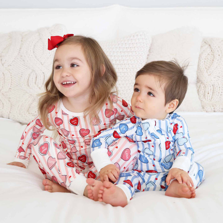 valentine's day sibling matching pajamas with stripes and conversation hearts in pink and blue