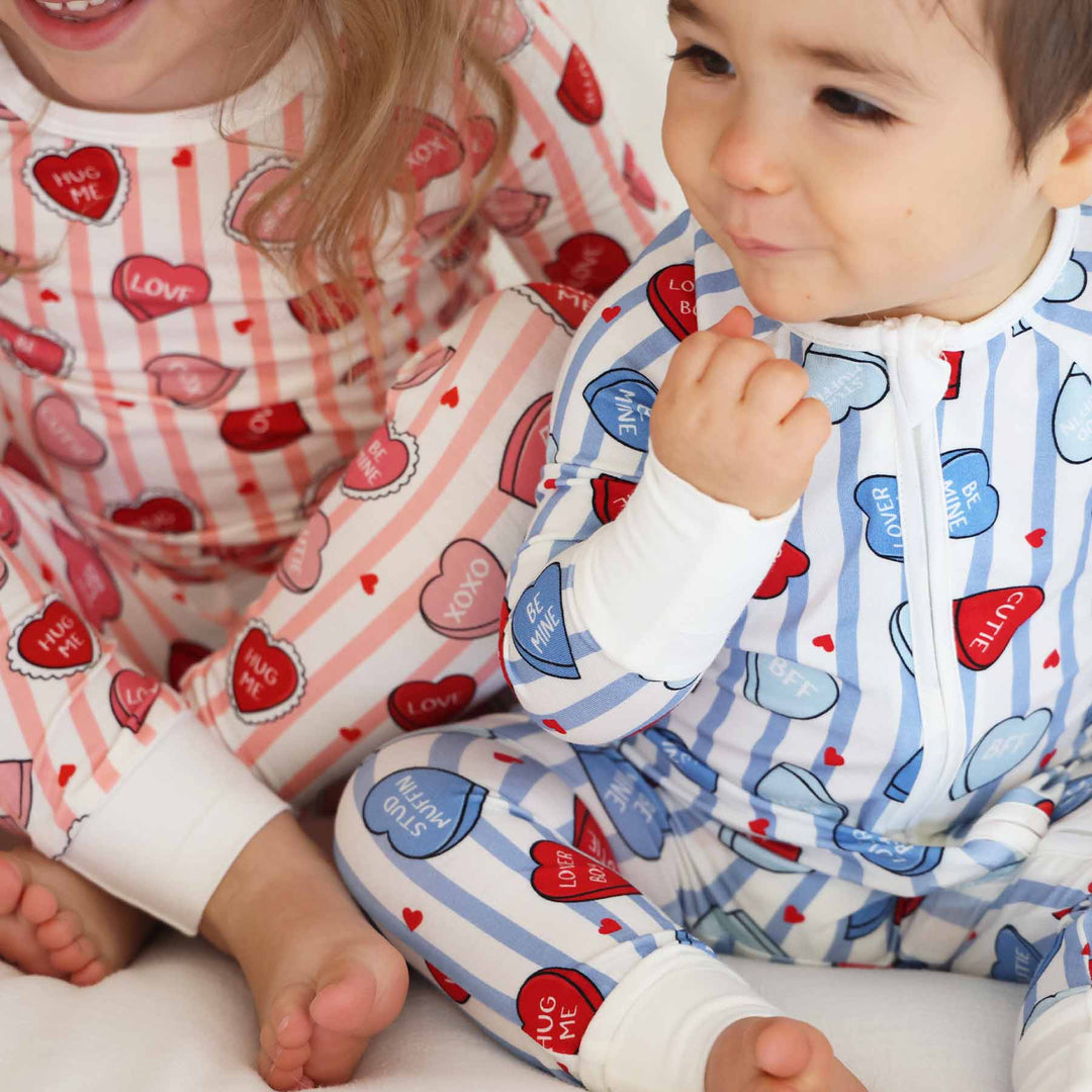 stripe and candy heart zip romper pajama with a matching two piece pajama set 
