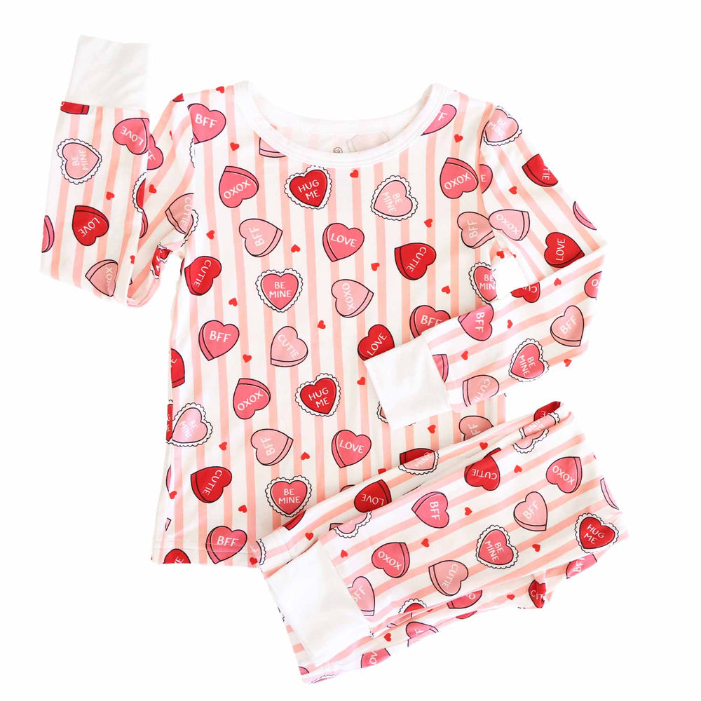 girl's pink stripe and candy heart two piece valentine's day pajama set for kids 