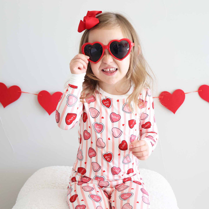 girl wearing valentine's day candy heart two piece pajama set 