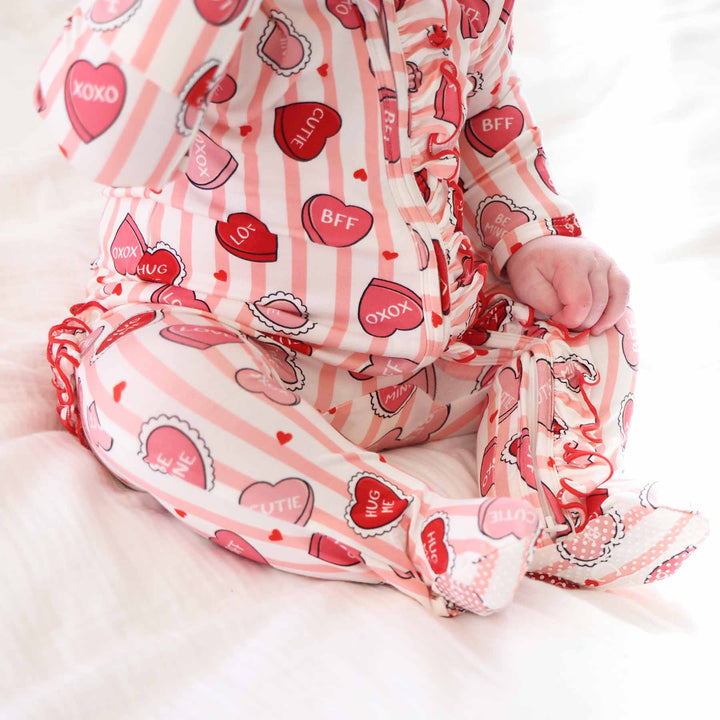 valentine's day baby girl zipper footie with grips on the feet and ruffles along the zipper and bottom 