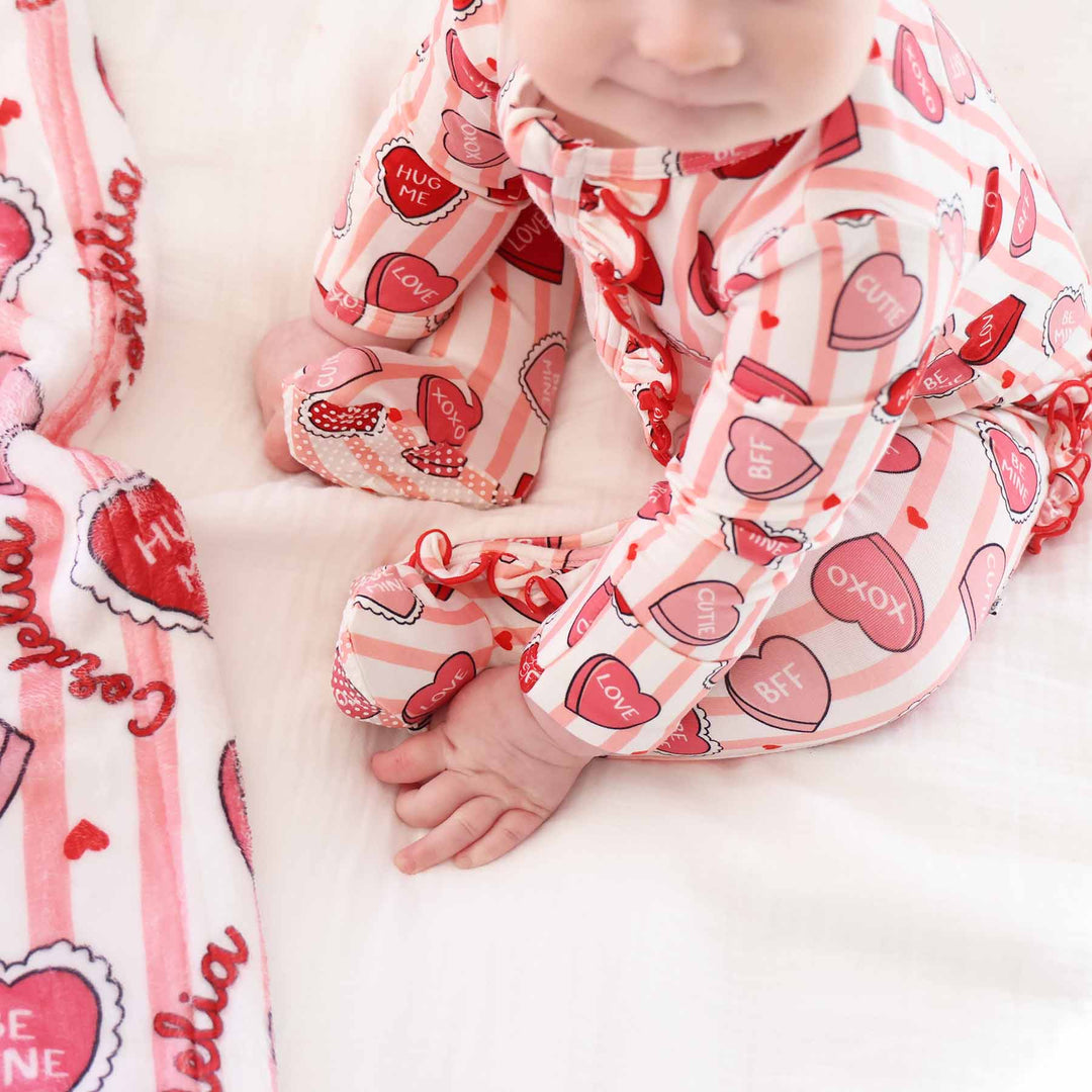 closeup of pink sweet like candy bamboo ruffle zipper footie for baby girls 