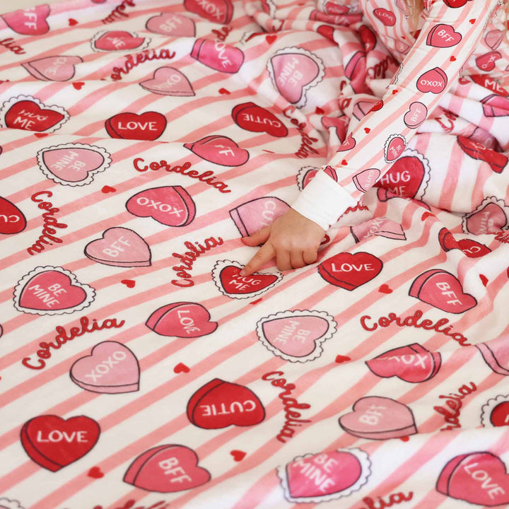 close up of sweet like candy personalized kids blanket in pink with matching two piece pajamas