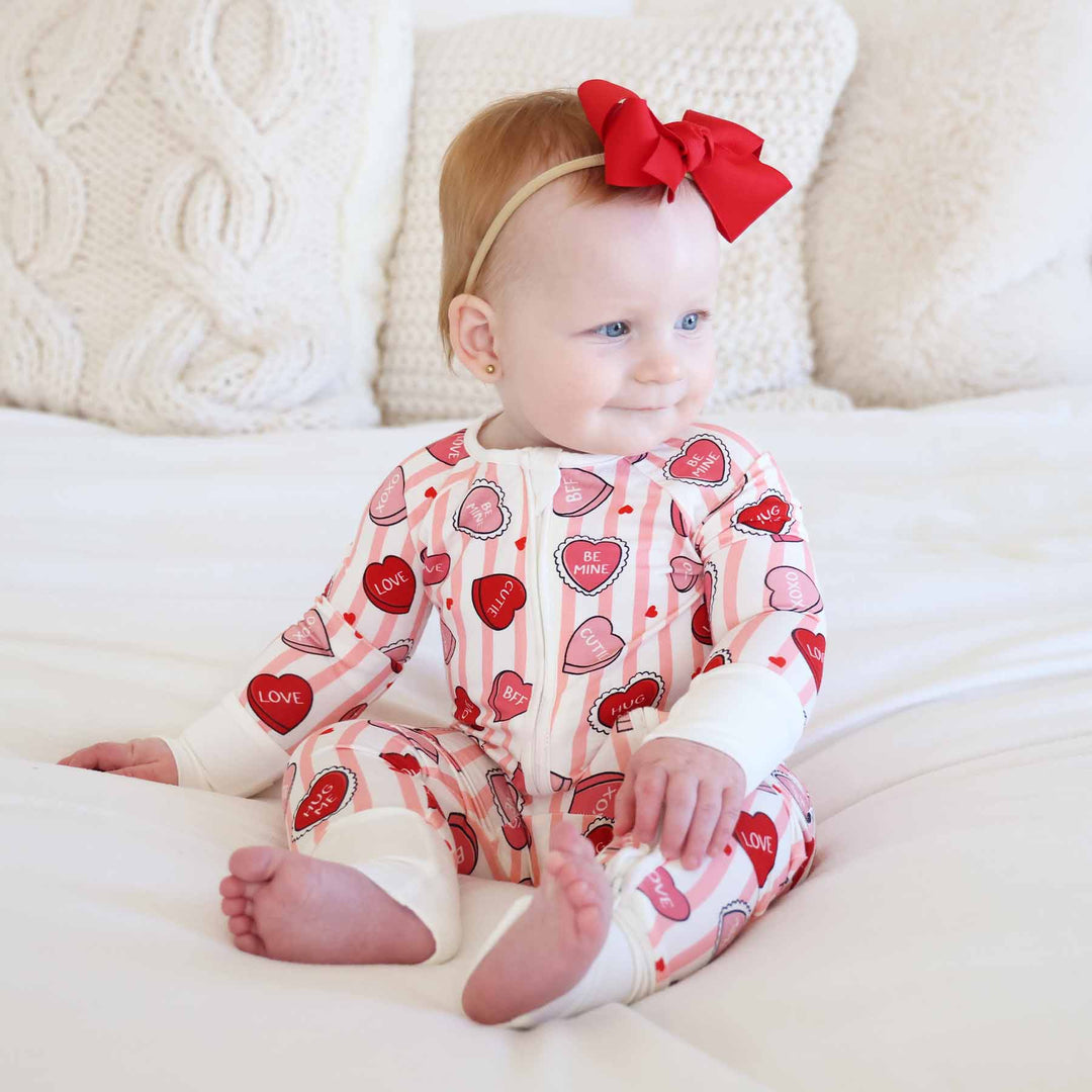long sleeve and pant convertible zip romper pajama for girls with stripes and candy hearts for valentine's day